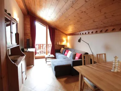 a living room with a couch and a table at 4 pièces spacieux bien équipé avec Wi-Fi et parking, au pied du ski bus - FR-1-572-241 in Les Carroz d'Araches