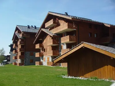 a building with balconies on the side of it at 4 pièces spacieux bien équipé avec Wi-Fi et parking, au pied du ski bus - FR-1-572-241 in Les Carroz d'Araches