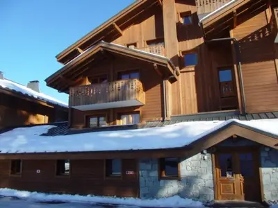 a large house with snow on the roof at 4 pièces spacieux bien équipé avec Wi-Fi et parking, au pied du ski bus - FR-1-572-241 in Les Carroz d'Araches