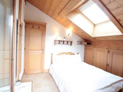 a bedroom with a bed and a skylight at 4 pièces spacieux bien équipé avec Wi-Fi et parking, au pied du ski bus - FR-1-572-241 in Les Carroz d'Araches
