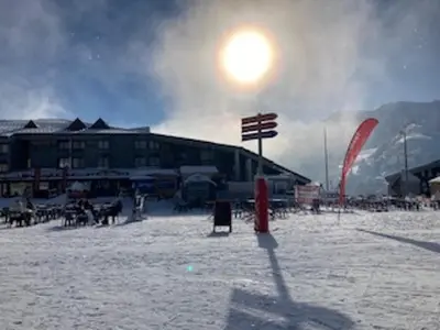 a kite flying in front of a building in the snow at Appartement skis aux pieds, balcon, parking privé - FR-1-624-15 in Samoëns