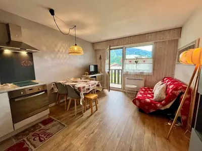 a kitchen and dining room with a table and a kitchen and a window at Studio cosy au centre de Samoëns avec animaux acceptés et parking - FR-1-624-70 in Samoëns