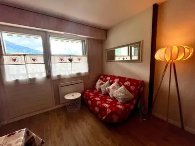 a kitchen with a table with a table cloth on it at Studio cosy au centre de Samoëns avec animaux acceptés et parking - FR-1-624-70 in Samoëns