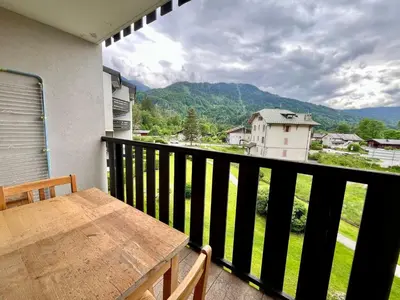 a living room with a red couch and a lamp at Studio cosy au centre de Samoëns avec animaux acceptés et parking - FR-1-624-70 in Samoëns