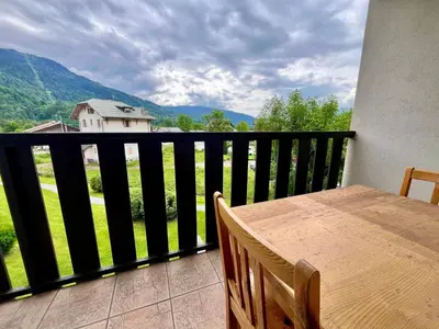a balcony with a table and a view of a mountain at Studio cosy au centre de Samoëns avec animaux acceptés et parking - FR-1-624-70 in Samoëns