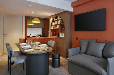 a kitchen and dining room with a table and a couch at RockyPop Flaine Appartements & Spa in Flaine