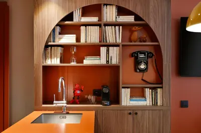 a kitchen with a sink and a book shelf at RockyPop Flaine Appartements & Spa in Flaine