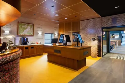 a lobby of a restaurant with a cash register and a counter at RockyPop Flaine Appartements & Spa in Flaine