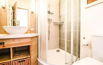 a bathroom with a shower and a sink at Cosy, modern 2-bed with fireplace & beautiful views in Flaine
