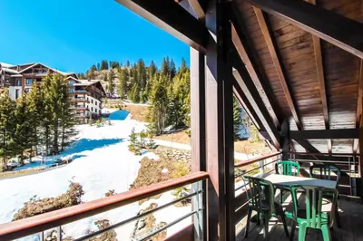 a view from a balcony with a table and chairs at Charming 6th-floor 2-bedroom apartment with fireplace in Flaine