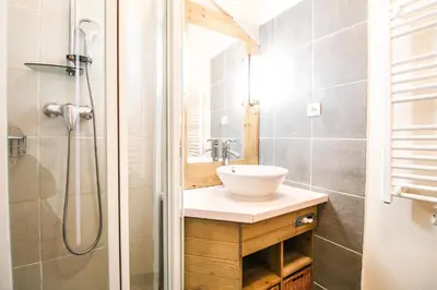 a bathroom with a sink and a shower at Charming 6th-floor 2-bedroom apartment with fireplace in Flaine