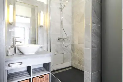 a bathroom with a sink and a shower at South-facing renovated 2-bed apartment Les Terrasses d'Eos in Flaine