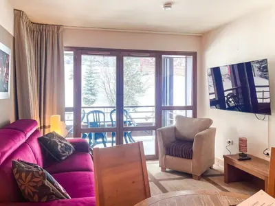 a living room with a purple couch and a chair at Large one-bedroom apartment, wheelchair adapted, Les Terrasses d'Eos in Flaine