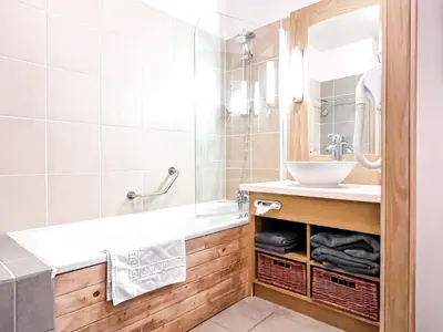 a bathroom with a sink and a mirror at Large one-bedroom apartment, wheelchair adapted, Les Terrasses d'Eos in Flaine