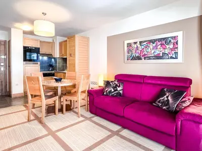 a living room with a red couch and a table at Large one-bedroom apartment, wheelchair adapted, Les Terrasses d'Eos in Flaine