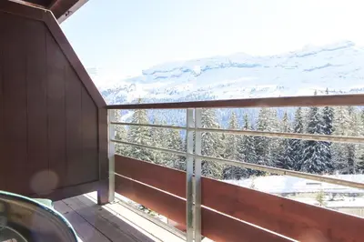 a view from the window of a room with snow covered trees at Stunning 3-bedroom apartment with mountain views in Flaine
