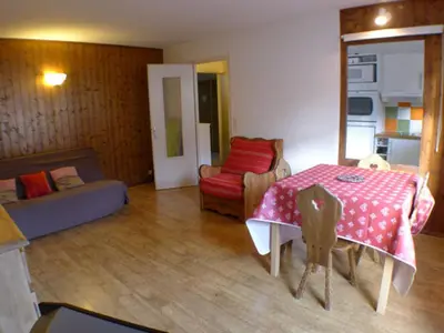 a living room with a table and a couch at T2 calme à Samoëns - 4 pers, animaux admis - FR-1-629-70 in Samoëns