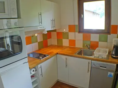a small kitchen with white cabinets and a sink at T2 calme à Samoëns - 4 pers, animaux admis - FR-1-629-70 in Samoëns