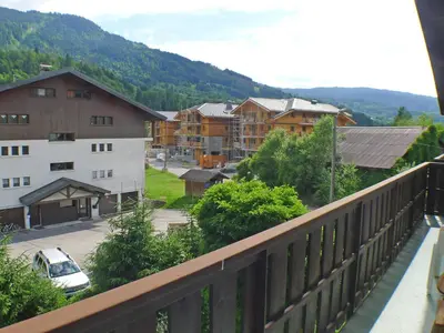 a view from a balcony of a town with buildings at Duplex 4 pièces avec balcon et Wifi à Samoëns pour 8 pers - FR-1-629-3 in Samoëns