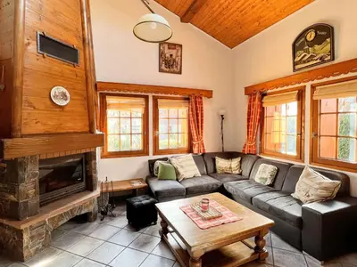 a living room with a couch and a fireplace at Chalet au centre de Samoëns avec jardin et cheminée - FR-1-624-17 in Samoëns
