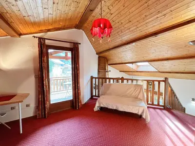 a bedroom with a bed and a wooden ceiling at Chalet au centre de Samoëns avec jardin et cheminée - FR-1-624-17 in Samoëns