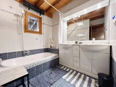 a bathroom with a tub and a sink at Chalet au centre de Samoëns avec jardin et cheminée - FR-1-624-17 in Samoëns
