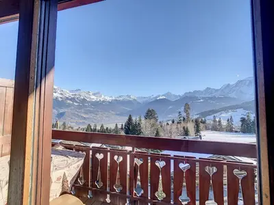 a balcony with a view of snow covered mountains at 2 pièces + mezzanine au pied des pistes à Combloux - FR-1-560-73 in Combloux