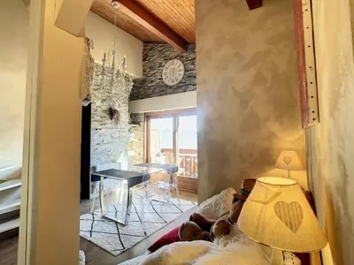 a living room with a couch and a table at 2 pièces + mezzanine au pied des pistes à Combloux - FR-1-560-73 in Combloux