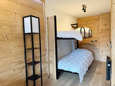 a bedroom with bunk beds in a cabin at Studio moderne avec balcon et parking dans Samoëns - FR-1-624-71 in Samoëns