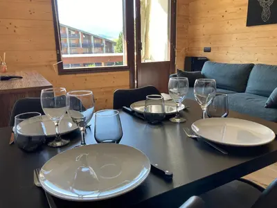 a table with plates and wine glasses on it at Studio moderne avec balcon et parking dans Samoëns - FR-1-624-71 in Samoëns
