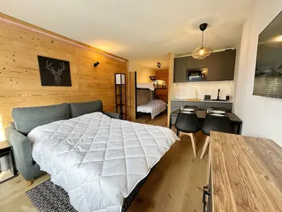 a bedroom with a bed and a desk and a bed sidx sidx sidx at Studio moderne avec balcon et parking dans Samoëns - FR-1-624-71 in Samoëns