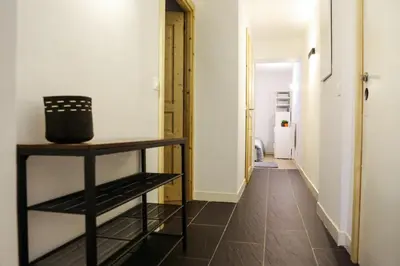 a hallway with white walls and a black shelf at Chalet Grand Balcon in Les Houches