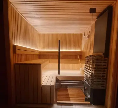 an empty sauna with wooden walls and wooden floors at Chalet Tontine, 3 bedrooms, sauna, terrace and great views ! in Les Houches
