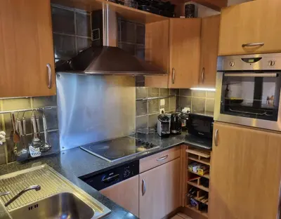a kitchen with a sink and a stove top oven at Chalet Tontine, 3 bedrooms, sauna, terrace and great views ! in Les Houches