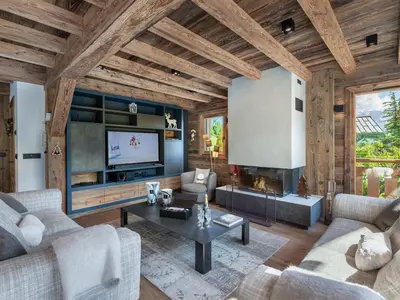 a living room with a couch and a tv at Chalet Luxe 12 Pers. Face aux Pistes avec Skiroom, Garage, Salle de Sport et Services Inclus - FR-1-569-19 in Demi-Quartier