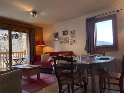 a living room with a table and a couch at Appartement T3 au centre de Samoëns avec balcon, WIFI et parking - FR-1-624-23 in Samoëns