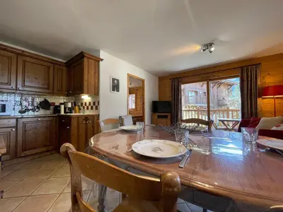 a dining room with a blue table and chairs at Appartement T3 au centre de Samoëns avec balcon, WIFI et parking - FR-1-624-23 in Samoëns