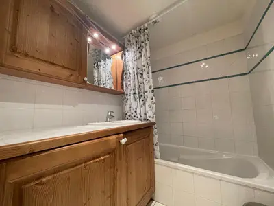 a bathroom with a sink and a bath tub at Appartement T3 au centre de Samoëns avec balcon, WIFI et parking - FR-1-624-23 in Samoëns