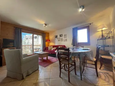 a living room with a table and chairs and a couch at Appartement T3 au centre de Samoëns avec balcon, WIFI et parking - FR-1-624-23 in Samoëns