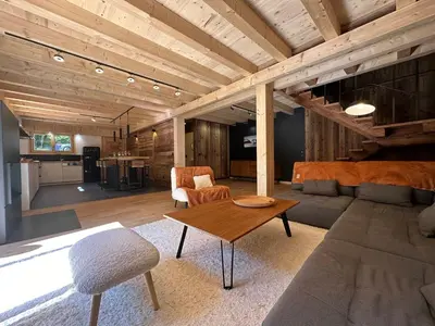 a living room with a couch and a table at Chalet moderne à Samoëns avec cheminée et terrasse - FR-1-624-5 in Samoëns
