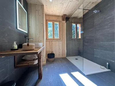 a bathroom with a shower with a glass door at Chalet moderne à Samoëns avec cheminée et terrasse - FR-1-624-5 in Samoëns
