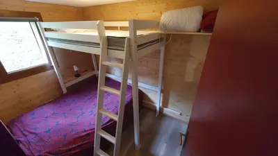 a room with two bunk beds and a ladder at Appartement l'Edel - Vue Massif Mont-Blanc in Saint-Gervais-les-Bains
