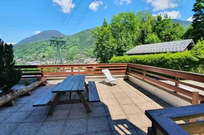 a picnic table on the roof of a house at Appartement l'Edel - Vue Massif Mont-Blanc in Saint-Gervais-les-Bains