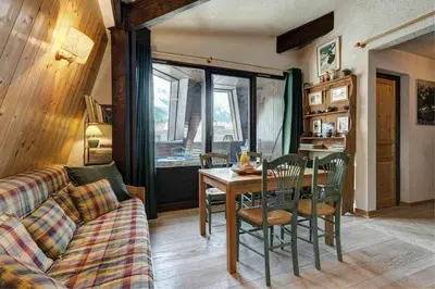 a living room with a couch and a table at Apartment Lachenal - Alpes Travel - Alpes Travel - Central Chamonix - sleeps 2-4 in Chamonix-Mont-Blanc