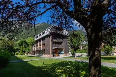 a large building with a tree in front of it at Apartment Lachenal - Alpes Travel - Alpes Travel - Central Chamonix - sleeps 2-4 in Chamonix-Mont-Blanc
