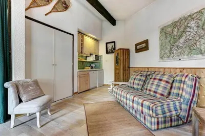 a living room with a couch and a chair at Apartment Lachenal - Alpes Travel - Alpes Travel - Central Chamonix - sleeps 2-4 in Chamonix-Mont-Blanc