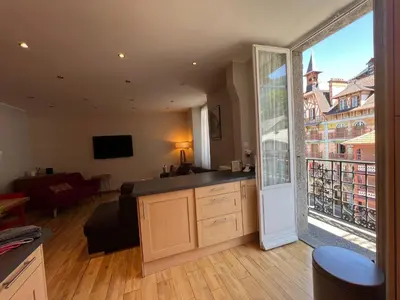 a living room with a kitchen and a large window at onlysaintg - Apartment Bernadette Spacious 4 bedrooms Great views, 120 m2 Only 500m from the centre and ski lift GREAT YEAR ROUND in Saint-Gervais-les-Bains