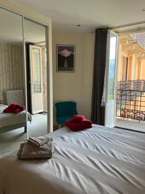 a bedroom with a large bed with red towels on it at onlysaintg - Apartment Bernadette Spacious 4 bedrooms Great views, 120 m2 Only 500m from the centre and ski lift GREAT YEAR ROUND in Saint-Gervais-les-Bains
