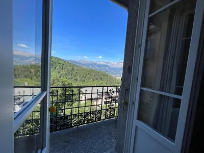 an open door to a balcony with a view at onlysaintg - Apartment Bernadette Spacious 4 bedrooms Great views, 120 m2 Only 500m from the centre and ski lift GREAT YEAR ROUND in Saint-Gervais-les-Bains