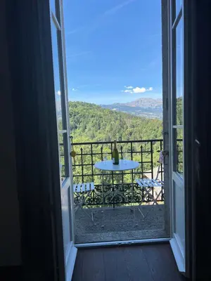 a view from a door of a balcony with a table at onlysaintg - Apartment Bernadette Spacious 4 bedrooms Great views, 120 m2 Only 500m from the centre and ski lift GREAT YEAR ROUND in Saint-Gervais-les-Bains